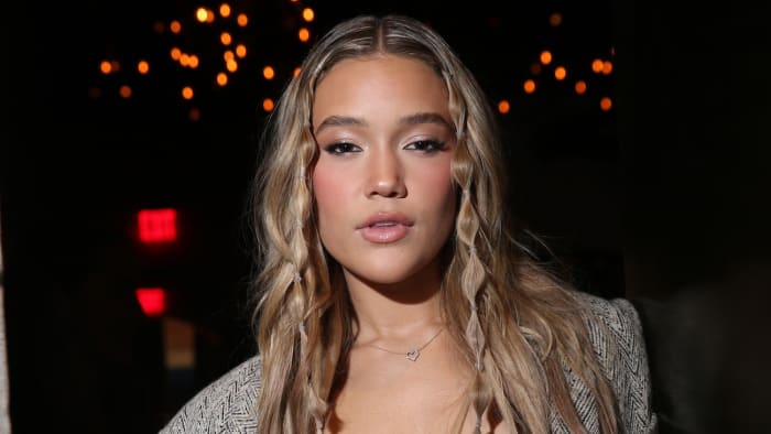 Olivia Ponton poses in a blazer and wears her dirty blonde hair down.